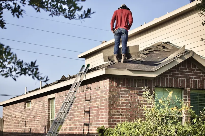 Professional roofer working on a residential roof in Toms Creek